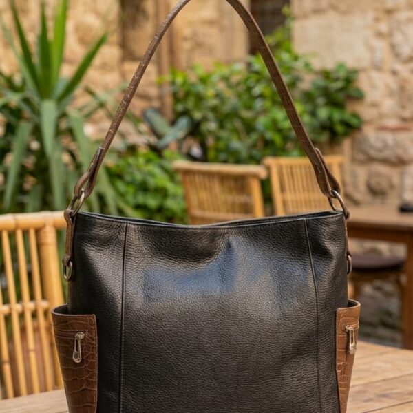 Leather shoulder bag with luxurious details and an external zip pocket